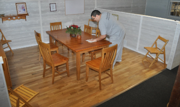 Practicing dusting a wood table Wauwatosa Cleaning Service